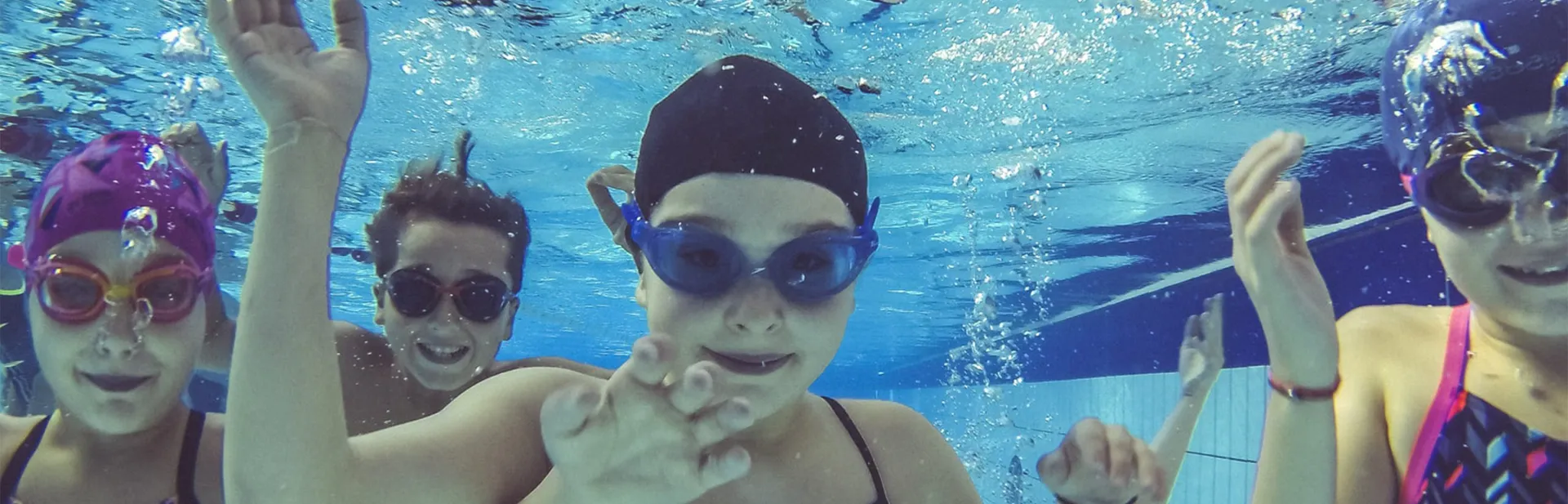 Cheerful children during a Sam sport swimming lesson.